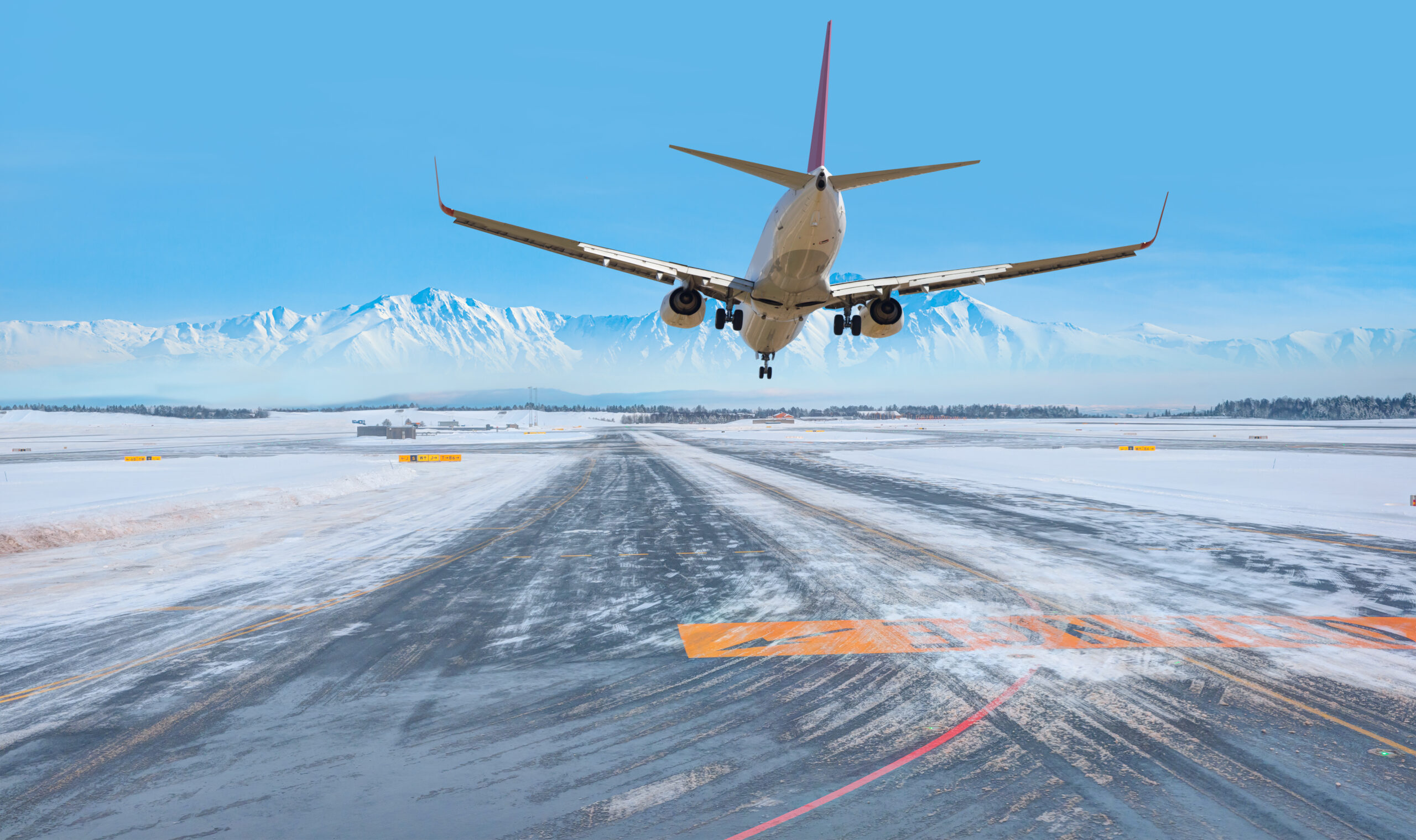 White passenger airplane landing runway on snowy airport Oslo, Norway White passenger airplane landing runway on snowy airport Oslo, Norway
