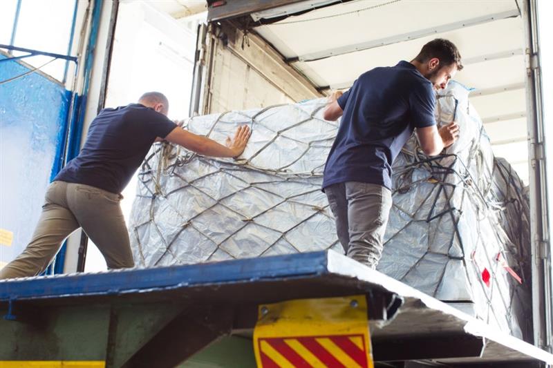 workers pushing freight into air freight container 2024 10 18 08 52 30 utc (1)